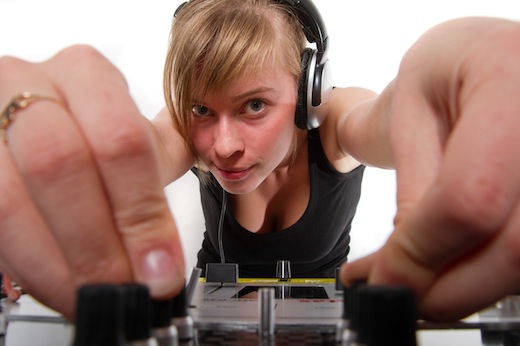 Teenage girl DJ adjusting sound levels