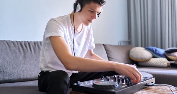 Young guy sitting on couch mixing