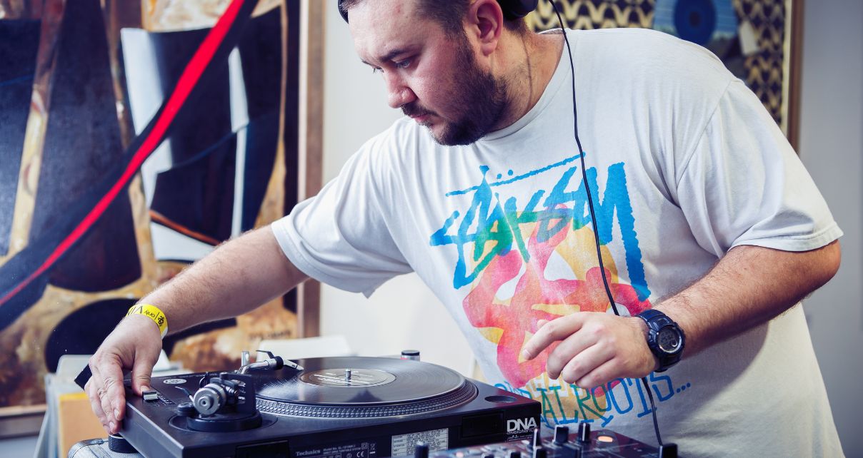 DJ adjusting the pitch on a turntable