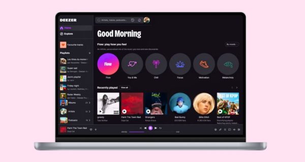 A silver laptop against a light pink background. The Deezer music streaming dashboard is displayed onscreen. 