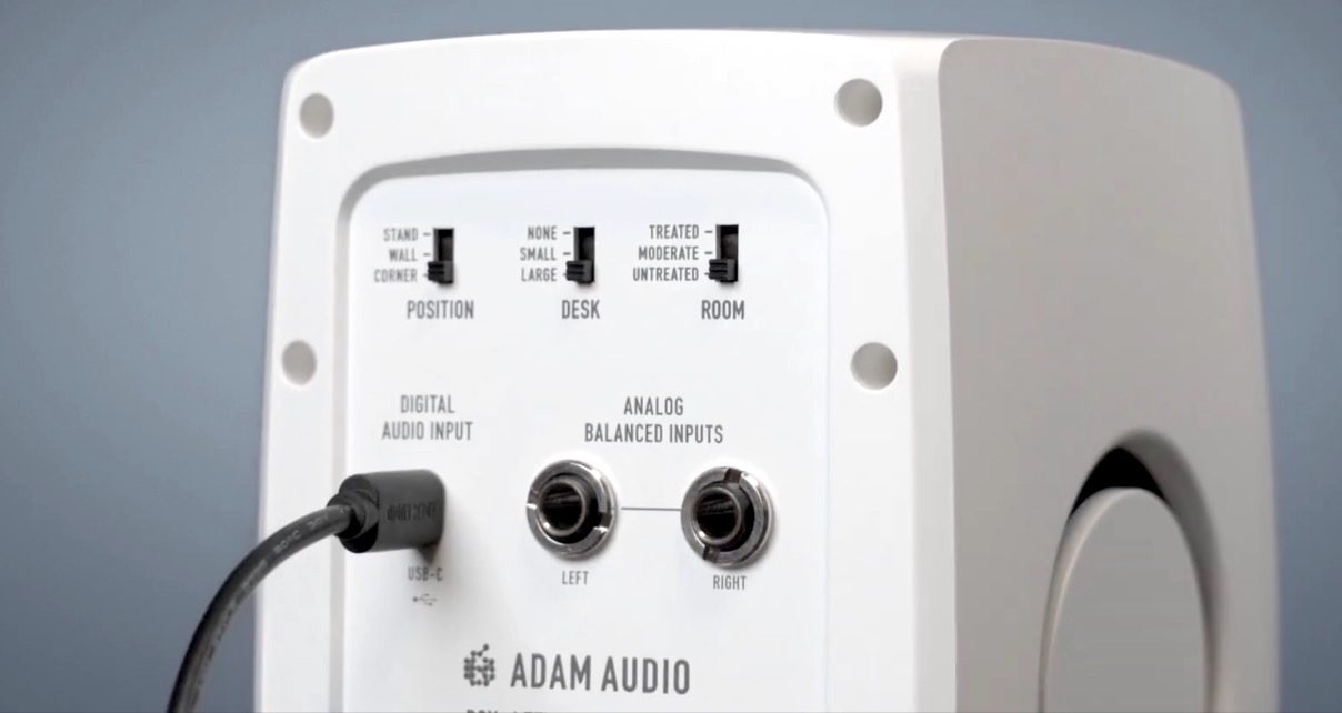Rear panel view of a white Adam Audio D3V speaker. 