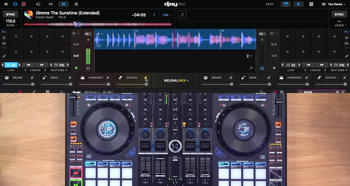 At the top of the screen is a Djay Pro software overlay. Underneath isa Reloop Mixon 8 DJ controller on a wooden desk. 