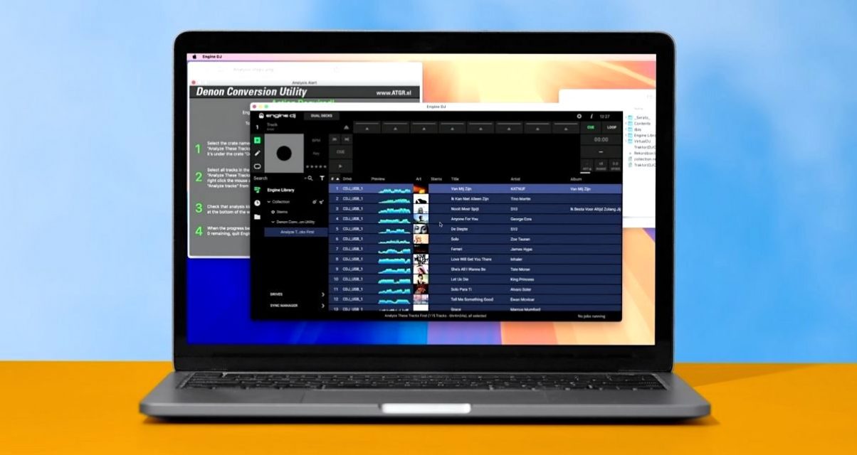 A silver MacBook displaying Engine DJ software and a utility panel. The laptop sits on a sand-coloured desk, and behind it is blue sky.
