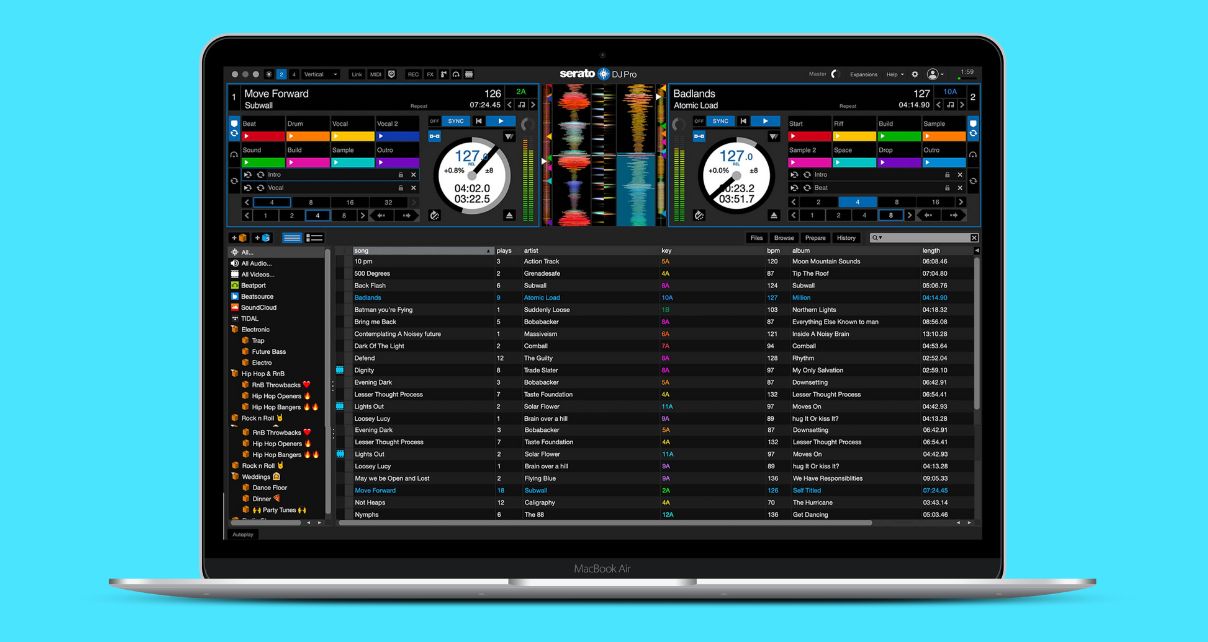A silver laptop displaying Serato DJ Pro software against a turquoise background.