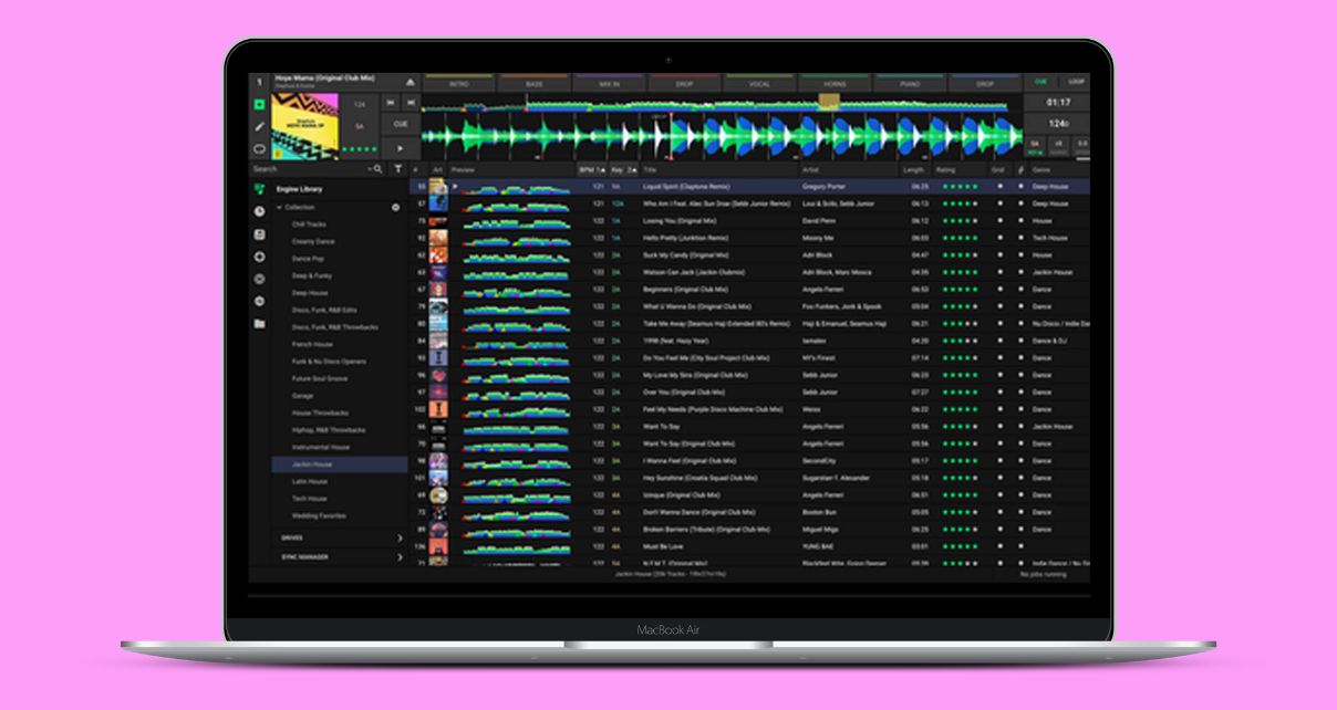 A silver laptop displaying Engine DJ software against a pink background.