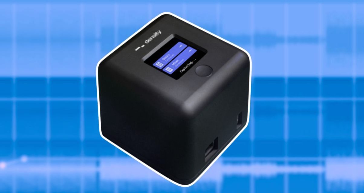 A compact black Density device featuring a small screen, controls, and logos, set against a light blue digital background.