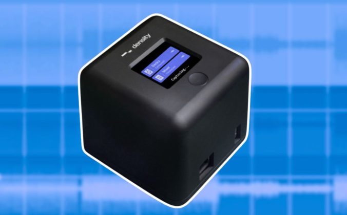 A compact black Density device featuring a small screen, controls, and logos, set against a light blue digital background.