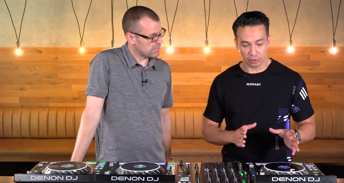 Phil Morse and Laidback Luke discuss DJ gear in a stylish studio, featuring a wooden backdrop and hanging lights.