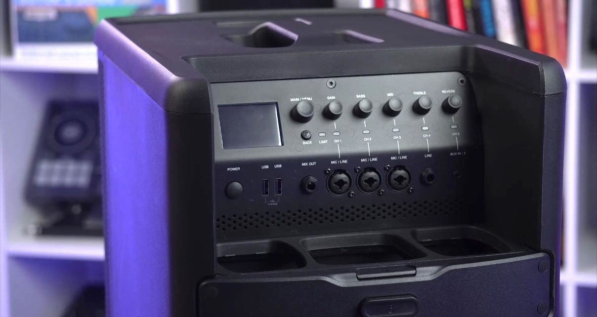 Close-up of the back panel of a portable JBL Eon One Mk2 speaker system featuring controls for sound adjustment, USB ports, and multiple input jacks.