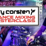 Artwork for a DJ course. On the right is Ferry Corsten DJing a festival, looking down at the decks. On the left is a white, black and red logo that reads "Ferry Corsten's Trance Mixing Masterclass". Beneath the logo is a cheering crowd.