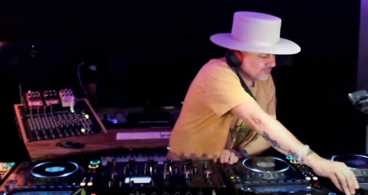 Louie Vega DJing behind pro gear in a nightclub