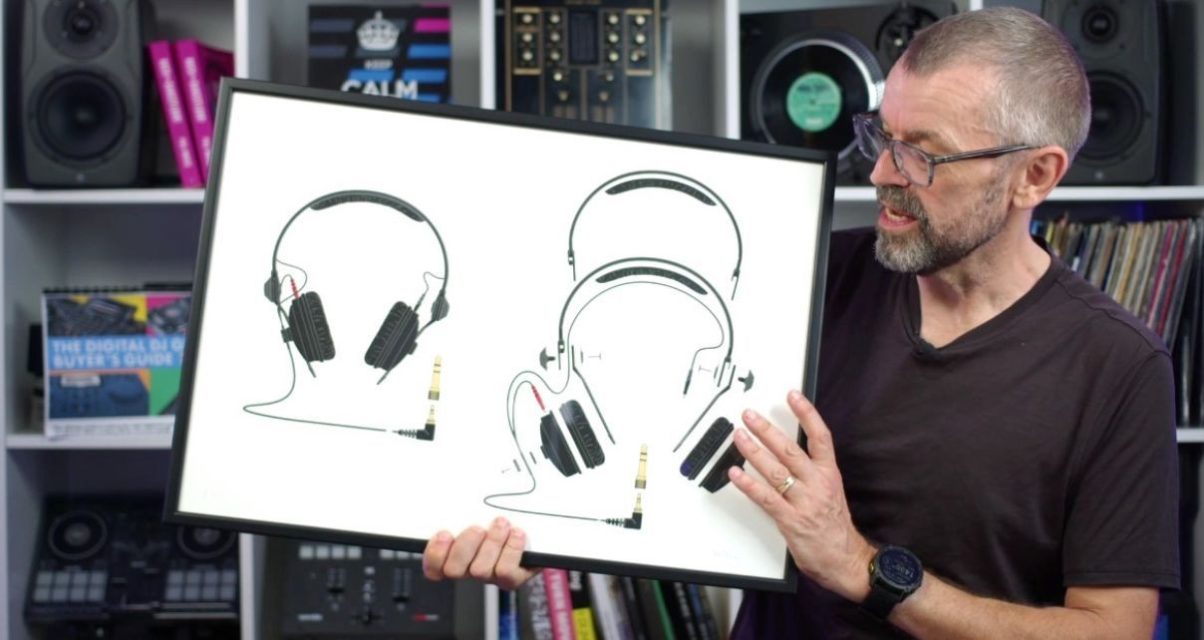 DJ tutor Phil Morse holds a framed illustration of Sennheiser HD-25 headphones with detailed schematic drawings against a white background. Behind him is a large white bookshelf containing various DJ gear, books, and trinkets.