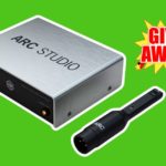A silver IK Multimedia Arc Studio box next to a black microphone, both outlined in white. In the top right is a yellow, red, white, and black graphic that says "Giveaway!". The background of the image is bright green.