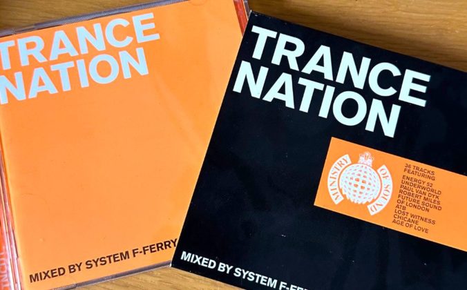 Orange, black and white Trance Nation CD and sleeve side by side on a light wooden desk.