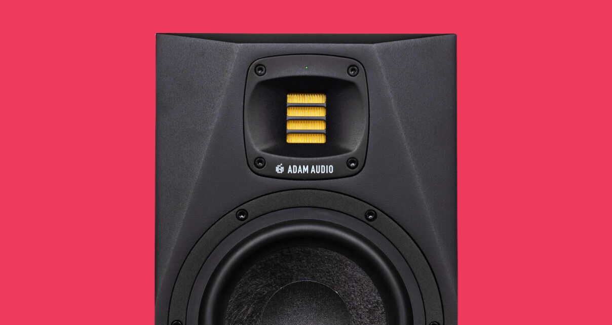 Zoomed in view of the ribbon tweeter on an Adam Audio A7V monitor against a red background. 