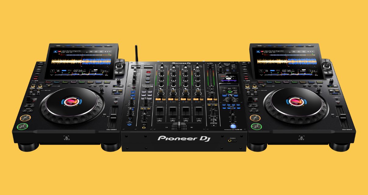 Two AlphaTheta CDJ-3000X players on either side of a DJM-A9 mixer. The background is mustard yellow.