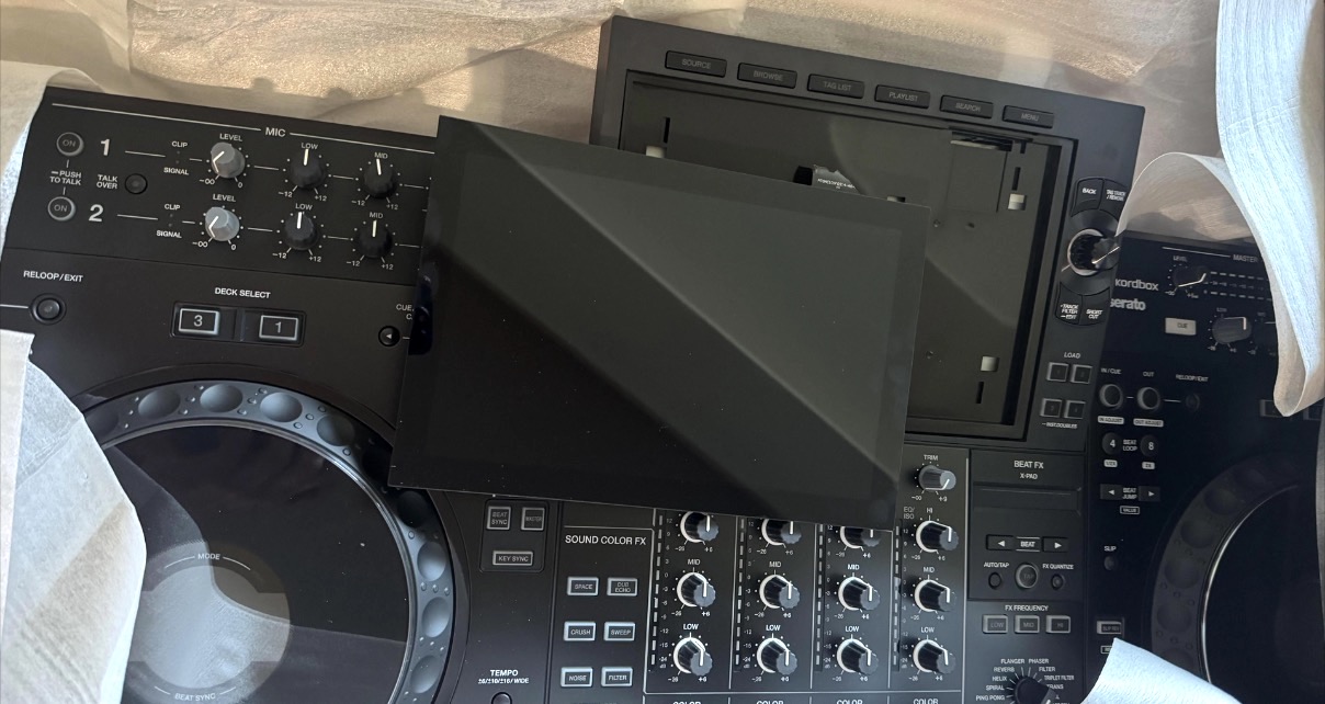 A black AlphaTheta XDJ-AZ standalone DJ system with the display screen broken off.