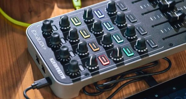 Angled view of an Allen & Heath Xone:K3 modular controller on a wooden table in a well-lit room. 