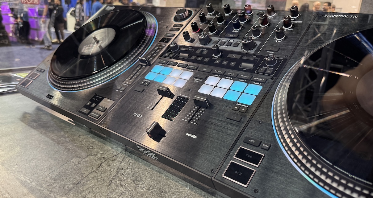 Angled top-down shot of a Hercules T10 controller. The design is mostly black and grey with white and blue on the performance pads.