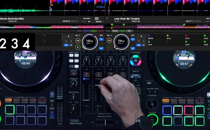 Overhead view of a Pioneer DJ DDJ-FLX10 controller showing a DJ's hand positioned over the mixer section's channel faders, with two tracks loaded on the displays showing "Feel My Needs (Extended Mix)" by Weiss at 125 BPM and "Lady (Hear Me Tonight)" by Modjo at 125.43 BPM.