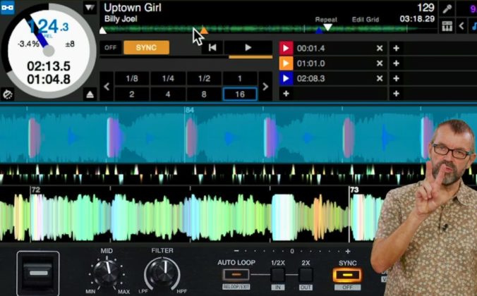 Phil Morse holds up two fingers against a DJ software screen showing Billy Joel's "Uptown Girl" loaded on a deck with a loop active.