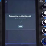 How To DJ From Your Laptop on Engine DJ Gear (No USB Needed!) Zoomed in view of a Rane System One screen that reads "Connecting to MackBook Air" with a loading circle icon.