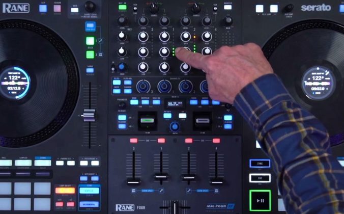 A close-up of a Rane System One DJ controller showing the mixer section, with a hand pointing to the channel meters near the top.