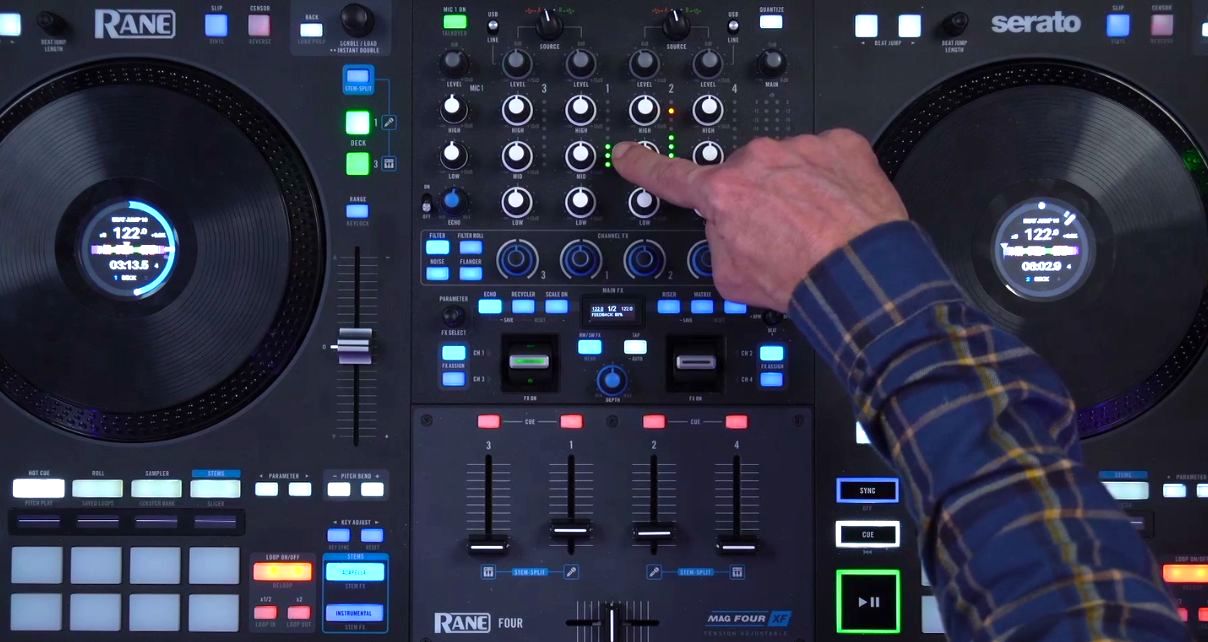 A close-up of a Rane System One DJ controller showing the mixer section, with a hand pointing to the channel meters near the top.