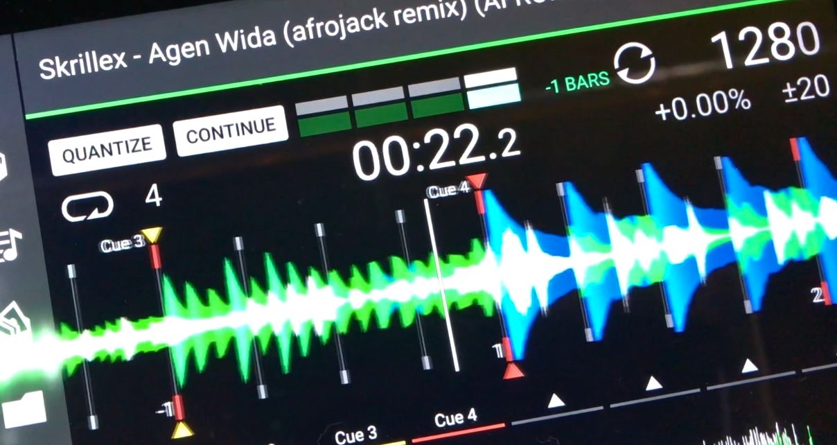 A close-up of an Engine DJ software screen showing the waveform of Skrillex's Agen Wida (Afrojack Remix) at 128 BPM, with cue points marked and a dense, blue and green waveform visible.