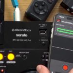 Recording Your Sets: The Single Best Way To Improve Your DJing A hand holds a smartphone running the Pioneer DJ REC app above a DJ controller, with other recording devices visible in the background.