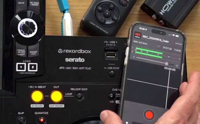 A hand holds a smartphone running the Pioneer DJ REC app above a DJ controller, with other recording devices visible in the background.